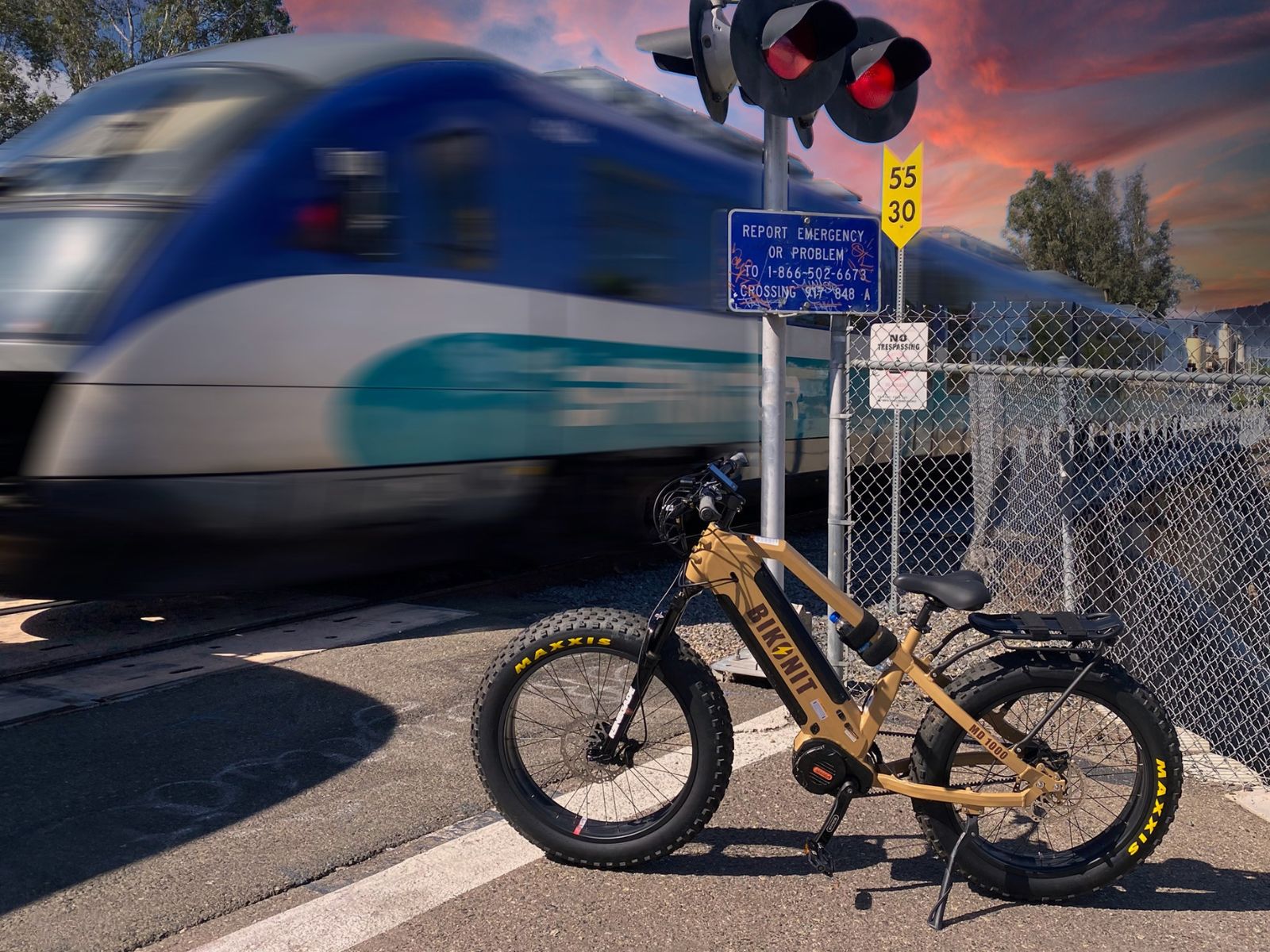 Bikonit MD1000 hunting ebike parked in front of a speeding train.